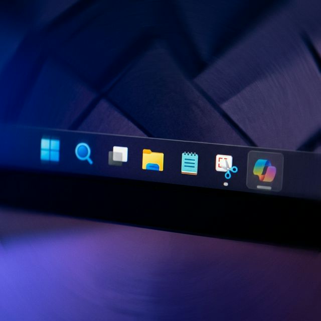 Windows 11 taskbar with Copilot AI icon dimmed, representing Microsoft's rollback of AI integrations